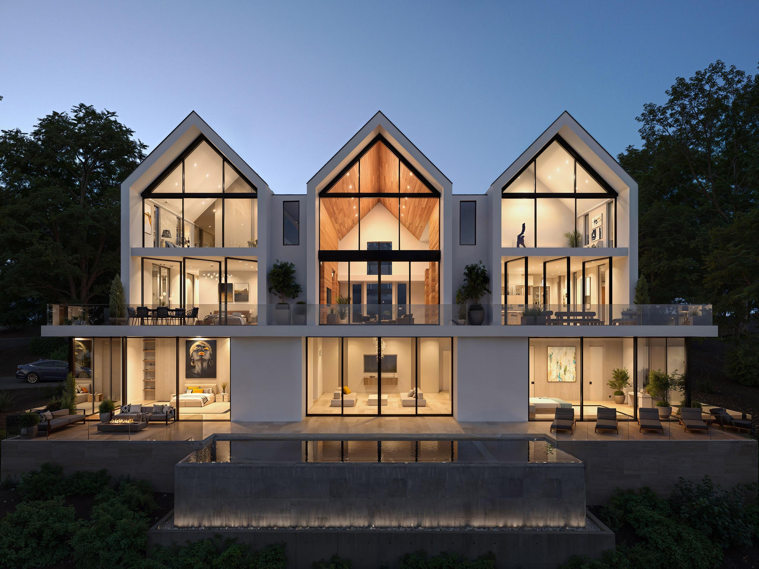 triple-gabled-modern-home-exterior Сучасний будинок з трьома двосхилими дахами та панорамними вікнами.