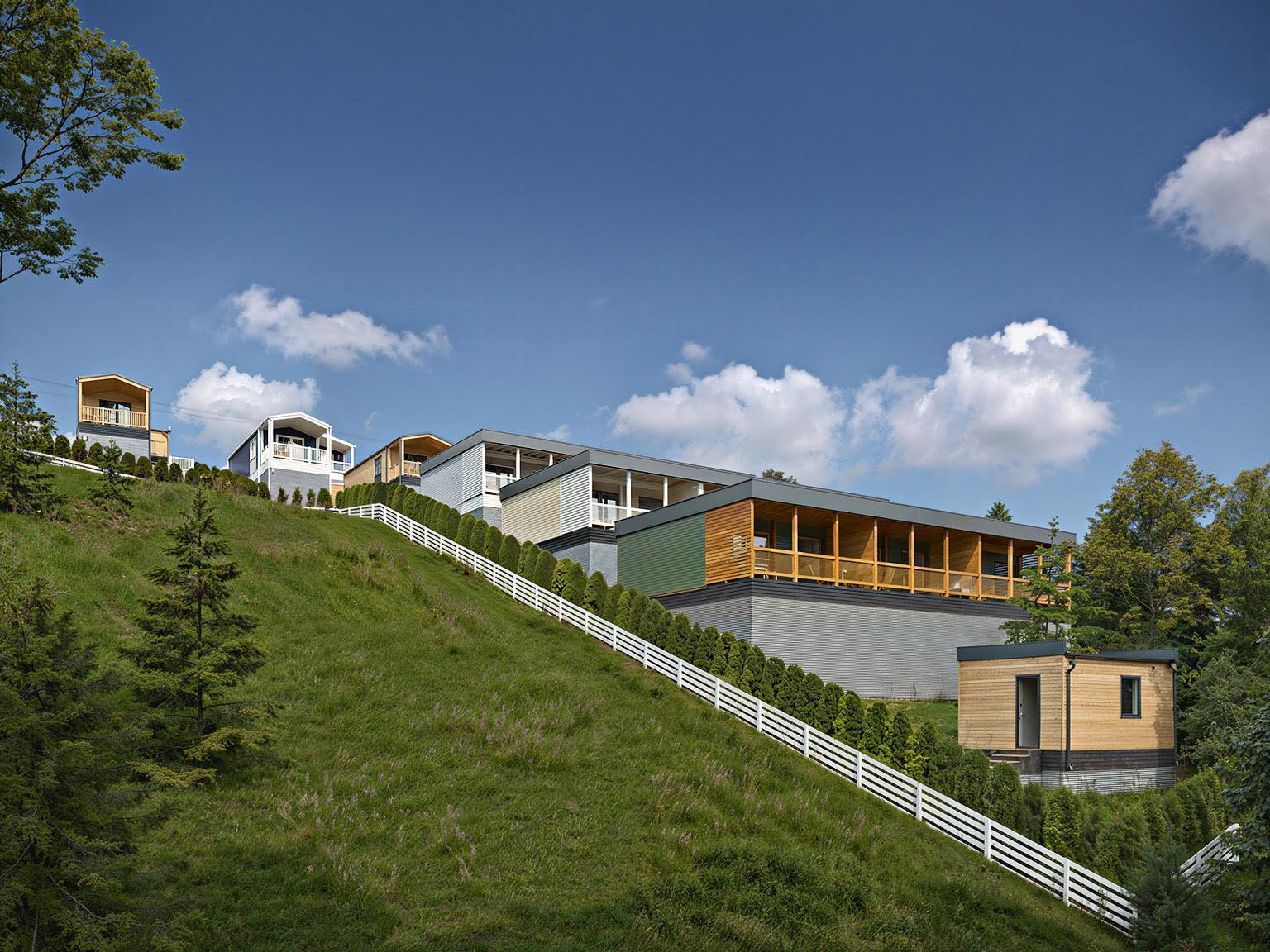 3D visualization of holiday houses on a hillside with a panoramic terrace and picturesque views